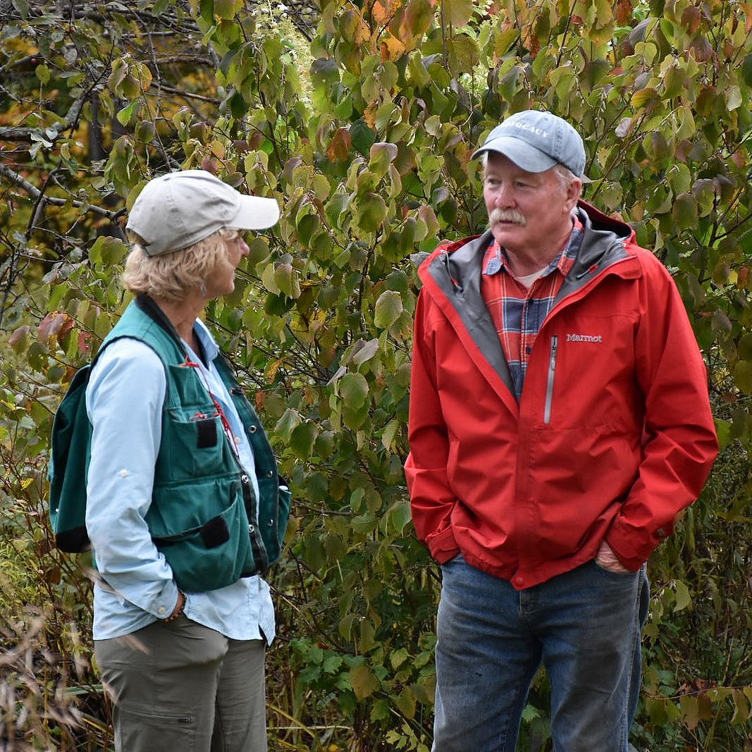 two people having a discussion in the outdoors