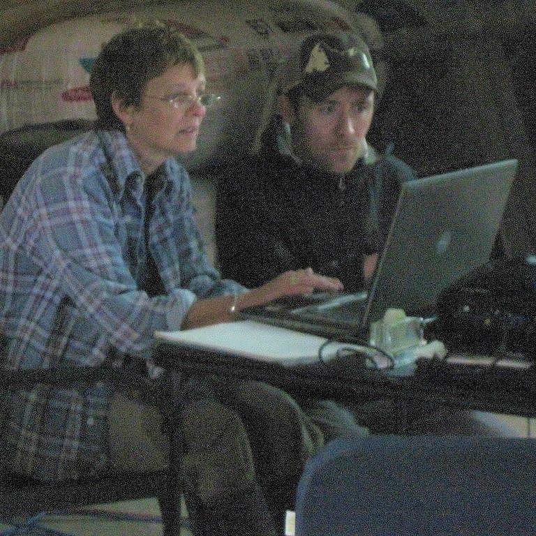 two people working together on a laptop